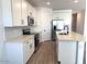 Open kitchen with stainless steel appliances, bright white cabinets, and a spacious island at 18240 W La Senda Dr, Surprise, AZ 85387