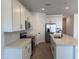 This modern kitchen features stainless steel appliances, white cabinets, and a center island with a sink at 18240 W La Senda Dr, Surprise, AZ 85387