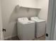 Laundry room featuring a washer and dryer set with a shelf for extra storage at 18240 W La Senda Dr, Surprise, AZ 85387