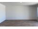 Bright living room featuring wood-look tile floors and neutral wall color at 18240 W La Senda Dr, Surprise, AZ 85387