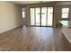Inviting living area featuring sliding glass doors and wood-look tile flooring at 18240 W La Senda Dr, Surprise, AZ 85387