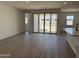 Spacious open-concept living room with tile floors and sliding glass doors to the backyard at 18240 W La Senda Dr, Surprise, AZ 85387