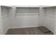 Spacious walk-in closet featuring ample shelving and carpet flooring at 18240 W La Senda Dr, Surprise, AZ 85387