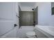 Well-lit bathroom features modern tiles, a bathtub-shower combo, and a sleek vanity with stylish fixtures at 1917 W Ashland Ave, Phoenix, AZ 85009