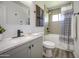 Modern bathroom with stylish vanity, updated fixtures, and a shower-tub combo with tile surround at 1917 W Ashland Ave, Phoenix, AZ 85009