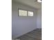 A bright bedroom with modern flooring, a window with natural light and a closet with modern doors at 1917 W Ashland Ave, Phoenix, AZ 85009