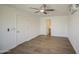 Bright bedroom featuring hard surface floors, white walls, modern ceiling fan, and mini-split system at 1917 W Ashland Ave, Phoenix, AZ 85009