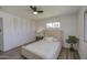 Cozy bedroom featuring a comfortable bed, ceiling fan, and closet with modern doors at 1917 W Ashland Ave, Phoenix, AZ 85009