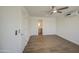 Bright bedroom featuring hard surface floors, white walls, modern ceiling fan, and mini-split system at 1917 W Ashland Ave, Phoenix, AZ 85009