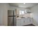 Modern kitchen with stainless steel appliances, white cabinets, and light countertops at 1917 W Ashland Ave, Phoenix, AZ 85009