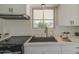 Close-up of kitchen featuring white cabinetry, sleek hardware, and modern fixtures for a contemporary look at 1917 W Ashland Ave, Phoenix, AZ 85009