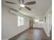 Spacious living room with hard surface flooring, white walls, modern ceiling fan and mini-split system at 1917 W Ashland Ave, Phoenix, AZ 85009
