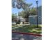 Community pool with black metal fence surrounded by well-maintained green grass at 2301 E University Dr # 111, Mesa, AZ 85213