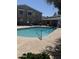 Community pool with dolphin figure, metal grab rail surrounded by lush greenery at 2301 E University Dr # 111, Mesa, AZ 85213
