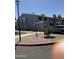 Exterior of townhome with neutral paint, driveway, landscaping, and street lamp at 2301 E University Dr # 111, Mesa, AZ 85213
