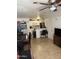 Well-lit kitchen featuring tile floors, white cabinets, and a cozy dining area at 2301 E University Dr # 111, Mesa, AZ 85213