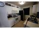 Functional kitchen with white cabinets, appliances and tile floor at 2301 E University Dr # 111, Mesa, AZ 85213