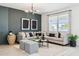 Stylish living room featuring a plush gray sectional, modern lighting, and elegant decor at 24079 W Cocopah St, Buckeye, AZ 85326