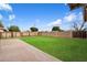 Large backyard showcasing a well-maintained lawn, concrete patio area and block fencing at 255 N Hunt E Dr, Mesa, AZ 85203