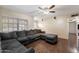 Bright living room featuring a large sectional couch, hardwood floors and lots of natural light at 255 N Hunt E Dr, Mesa, AZ 85203