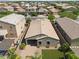 Aerial view of a single-story home featuring a tile roof, desert landscaping, and a brick-paved backyard and carport at 2759 E Mews Rd, Gilbert, AZ 85298