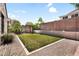 Backyard with artificial grass and gravel, surrounded by a block fence at 2759 E Mews Rd, Gilbert, AZ 85298