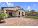 Private backyard features a brick patio, synthetic grass area, and mature landscaping at 2759 E Mews Rd, Gilbert, AZ 85298