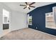 Bright bedroom with a cozy carpet, ceiling fan, and natural light from a large window at 2759 E Mews Rd, Gilbert, AZ 85298