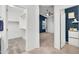 Spacious bedroom featuring a ceiling fan, large window, and walk-in closet for ample storage at 2759 E Mews Rd, Gilbert, AZ 85298