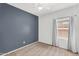 Cozy bedroom featuring a gray accent wall and bright window at 2759 E Mews Rd, Gilbert, AZ 85298