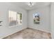 Bright bedroom with tile flooring, neutral walls and natural light from two windows at 2759 E Mews Rd, Gilbert, AZ 85298