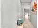 Hallway leading to living area with tile flooring, neutral walls, and decorative artwork at 2759 E Mews Rd, Gilbert, AZ 85298