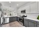 Modern kitchen boasts stainless steel appliances, white countertops, and gray and white cabinetry at 2759 E Mews Rd, Gilbert, AZ 85298
