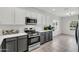 Stylish kitchen with white countertops, stainless steel appliances, and gray and white cabinets at 2759 E Mews Rd, Gilbert, AZ 85298