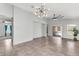 Open living room featuring tile floors, neutral paint, backyard access, and modern light fixture at 2759 E Mews Rd, Gilbert, AZ 85298