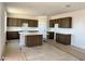 Spacious kitchen featuring dark wood cabinetry, a large island, and white quartz countertops at 3033 E Mecklenburg Way, San Tan Valley, AZ 85143