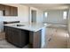 Kitchen island features a sink and quartz countertop with modern cabinetry at 3033 E Mecklenburg Way, San Tan Valley, AZ 85143