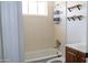 Bathroom has a shower-tub combo with a vanity and storage racks at 3802 W Mulberry Dr, Phoenix, AZ 85019