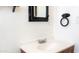 Bathroom with a modern vanity, single sink and a black-framed mirror at 3802 W Mulberry Dr, Phoenix, AZ 85019