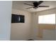 Bright bedroom featuring a ceiling fan, large windows, and neutral wall color at 3802 W Mulberry Dr, Phoenix, AZ 85019