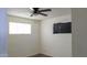 Bedroom with ceiling fan, light-colored walls, and hardwood flooring at 3802 W Mulberry Dr, Phoenix, AZ 85019
