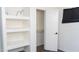A bright walk-in closet with an open doorway and shelving for organized storage at 3802 W Mulberry Dr, Phoenix, AZ 85019