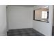 An empty dining room shows a large window and classic tile flooring at 3802 W Mulberry Dr, Phoenix, AZ 85019