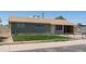 Single story home with neutral siding, brown roof, chain link fence, and an arid lawn at 3802 W Mulberry Dr, Phoenix, AZ 85019