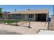 Single story home with neutral siding, brown roof, chain link fence, covered carport, and concrete driveway at 3802 W Mulberry Dr, Phoenix, AZ 85019