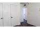 Hallway featuring white doors, black hardware, light walls and wood look floors at 3802 W Mulberry Dr, Phoenix, AZ 85019