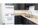 A cozy kitchen showcases dark cabinets, a double sink, granite counters and a white gas range at 3802 W Mulberry Dr, Phoenix, AZ 85019