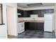 Galley kitchen with white appliances and dark cabinets at 3802 W Mulberry Dr, Phoenix, AZ 85019