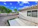This backyard has a concrete patio, block wall fencing, and a patch of green near the back of the property at 4144 N 109Th Ave, Phoenix, AZ 85037