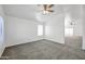 Cozy bedroom with neutral carpet, a ceiling fan, and a window providing ample natural light at 4144 N 109Th Ave, Phoenix, AZ 85037